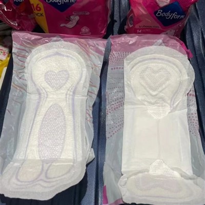 Treated Fluff Pulp for Sanitary Napkin Absorbent Layer